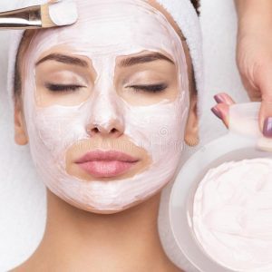 woman-receiving-facial-mask-spa-beauty-salon-young-beautiful-165392217