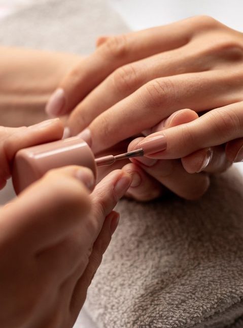 close-up-manicurist-applying-nail-polish-480x702